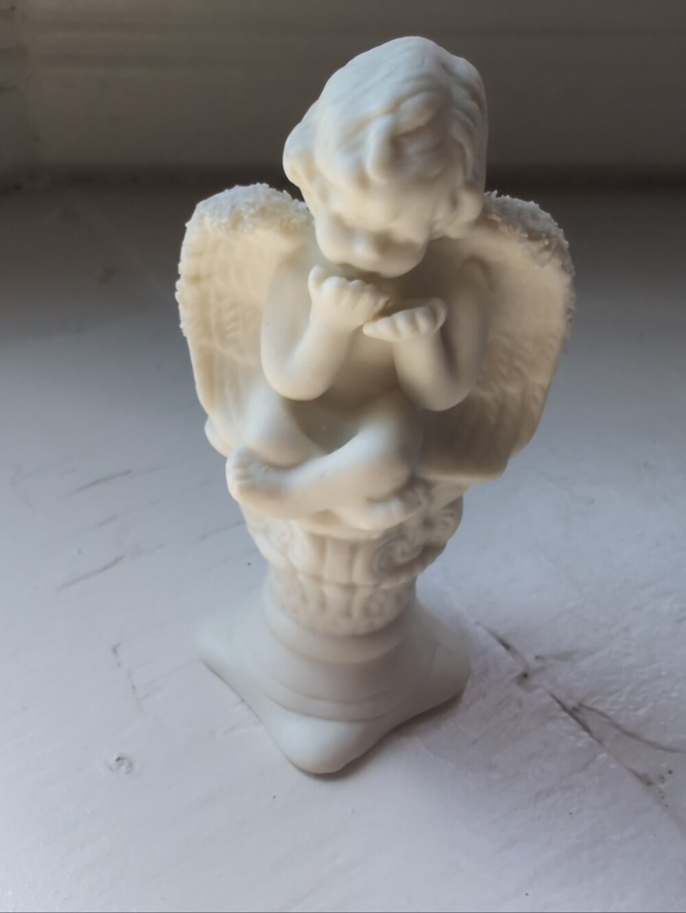 White bisque porcelain cherub figurine or candle holder